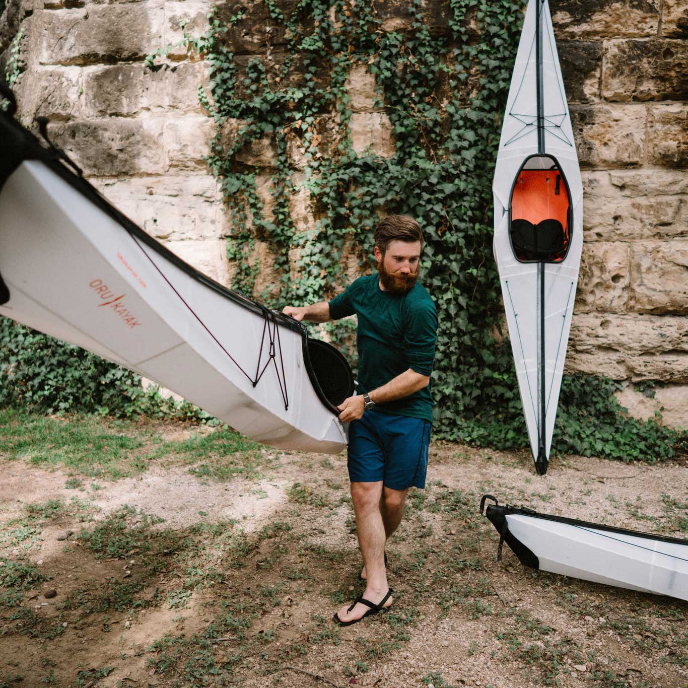 man carrying bay st kayak