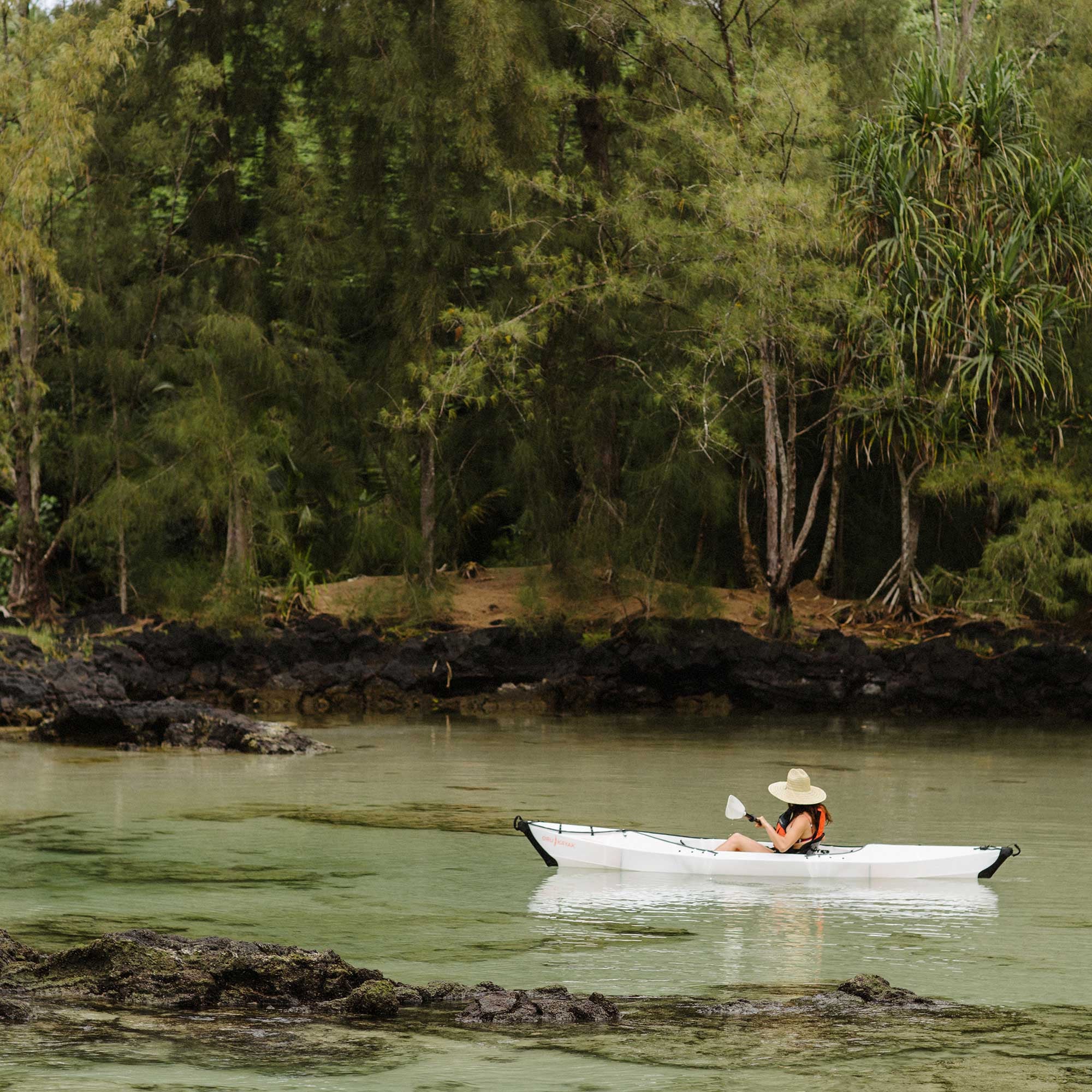 Woman paddling on a beach lt kayak 