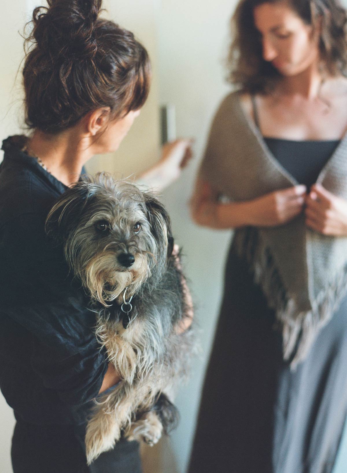 jess brown styling a model and holding her dog rocco