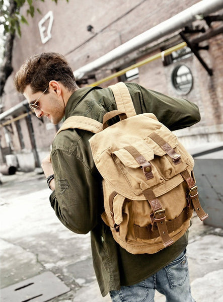 Stylish man wearing light-brown military travel backpack