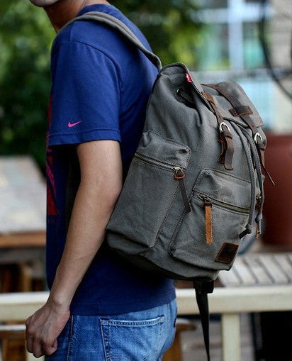 Stylish man wearing the casual canvas backpack by Serbags - side view