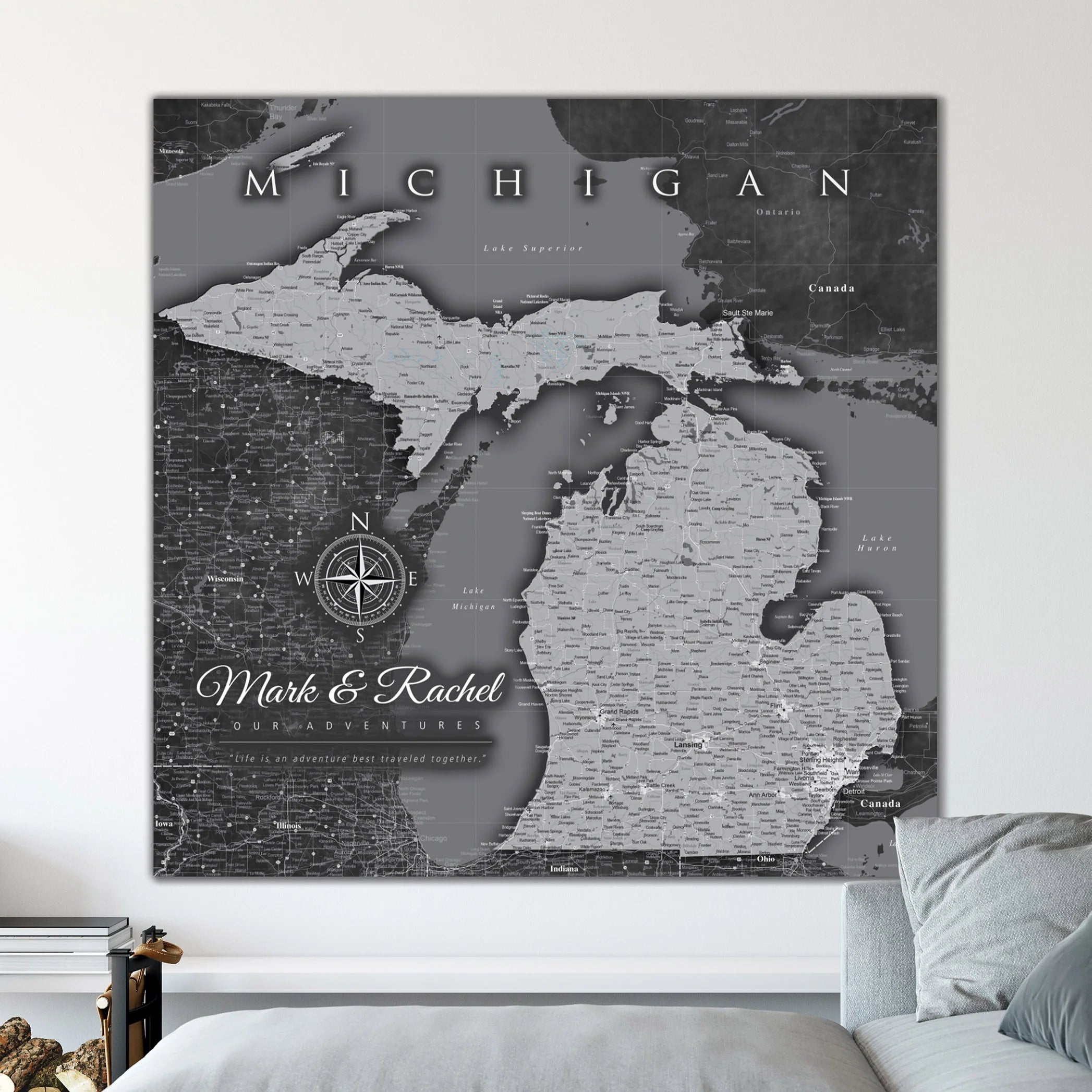 Gray map of Michigan on a wall with the inscription 'Mark & Rachel Our Adventures.'