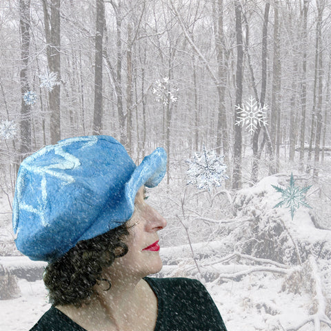 Digital Collage of Pale Blue Cap set against a snowy forest.