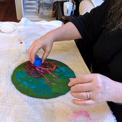 Carla laying out Merino wool for her felted vessel.