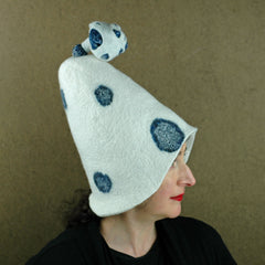 An extra big hat in white with blue polka dots that was inspired by Mushrooms