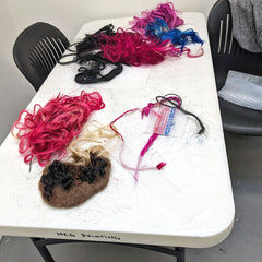 Hair extensions on table with some students' projects