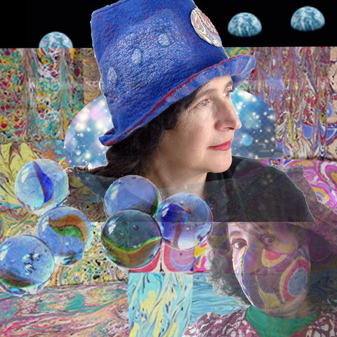 Blue Pilgrim Top Hat with Striped Brim set against a field of marbelized cotton fabric and glass marbles, with a backdrop of the famouse Earthrise photo behind me.