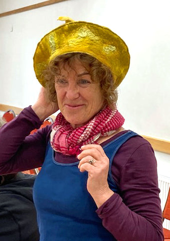 Mary trying on a yellow felted beret