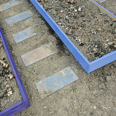 Raised beds painted with milk paint for edible front yard.