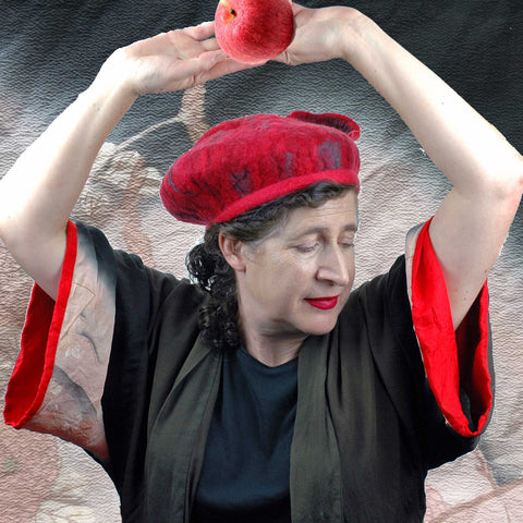 Woman wearing a vintage kimono and holding and apple. Red and Gray Felted Beret.
