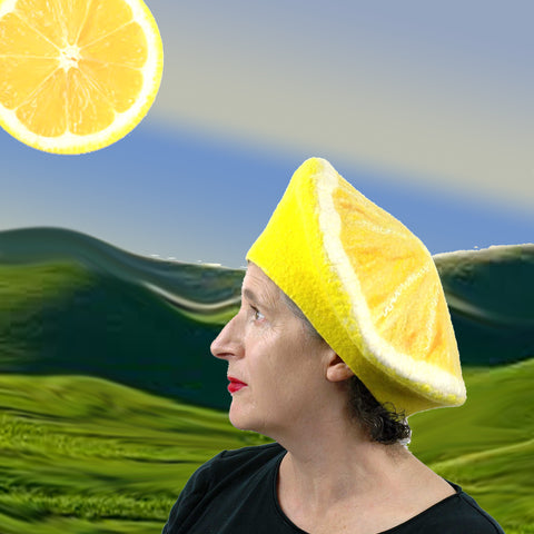 Digital Collage of a Lemon Beret set against a Telletubbie like landscape with a slice of lemon sun.