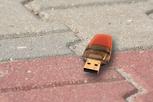 unencrypted flash drive dropped on a sidewalk