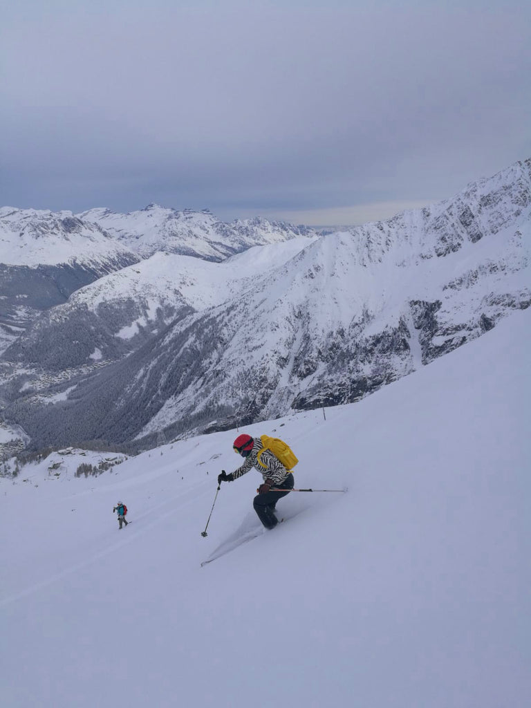 Skiing with yellow backpack