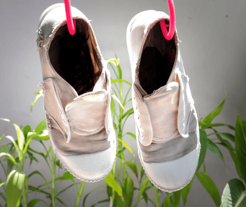 Hung canvas shoes dry under sunlight