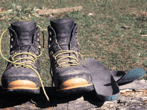 Snow shoes and insoles drying under sun