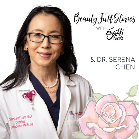 Dr. Serena Chen has long dark hair and is wearing a white lab coat with a pink uterus pin and glasses.