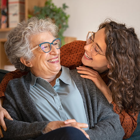 woman with her grandmother, embracing her, both are smiling