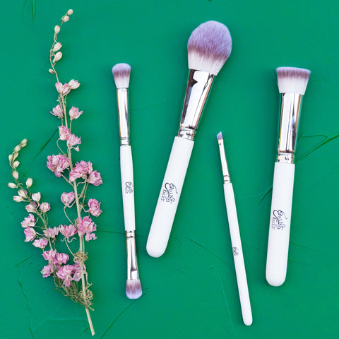 white makeup brushes on green background