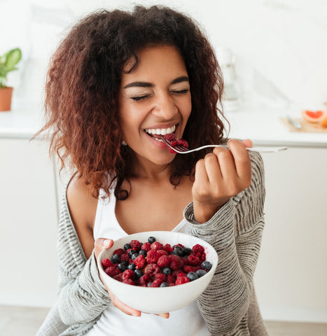 woman eating berries