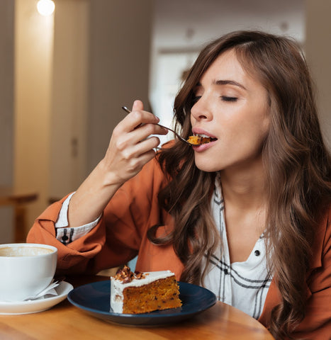 woman eating cake with coffee