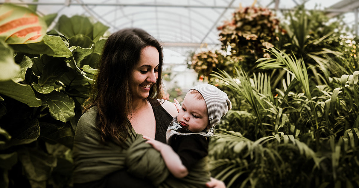 A woman and baby in a greenhouse