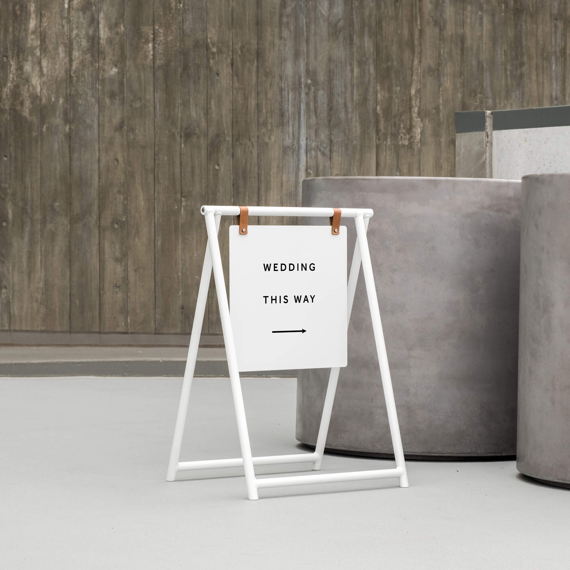 An A-Frame sandwich board displaying a message for directing wedding guests at a wedding venue