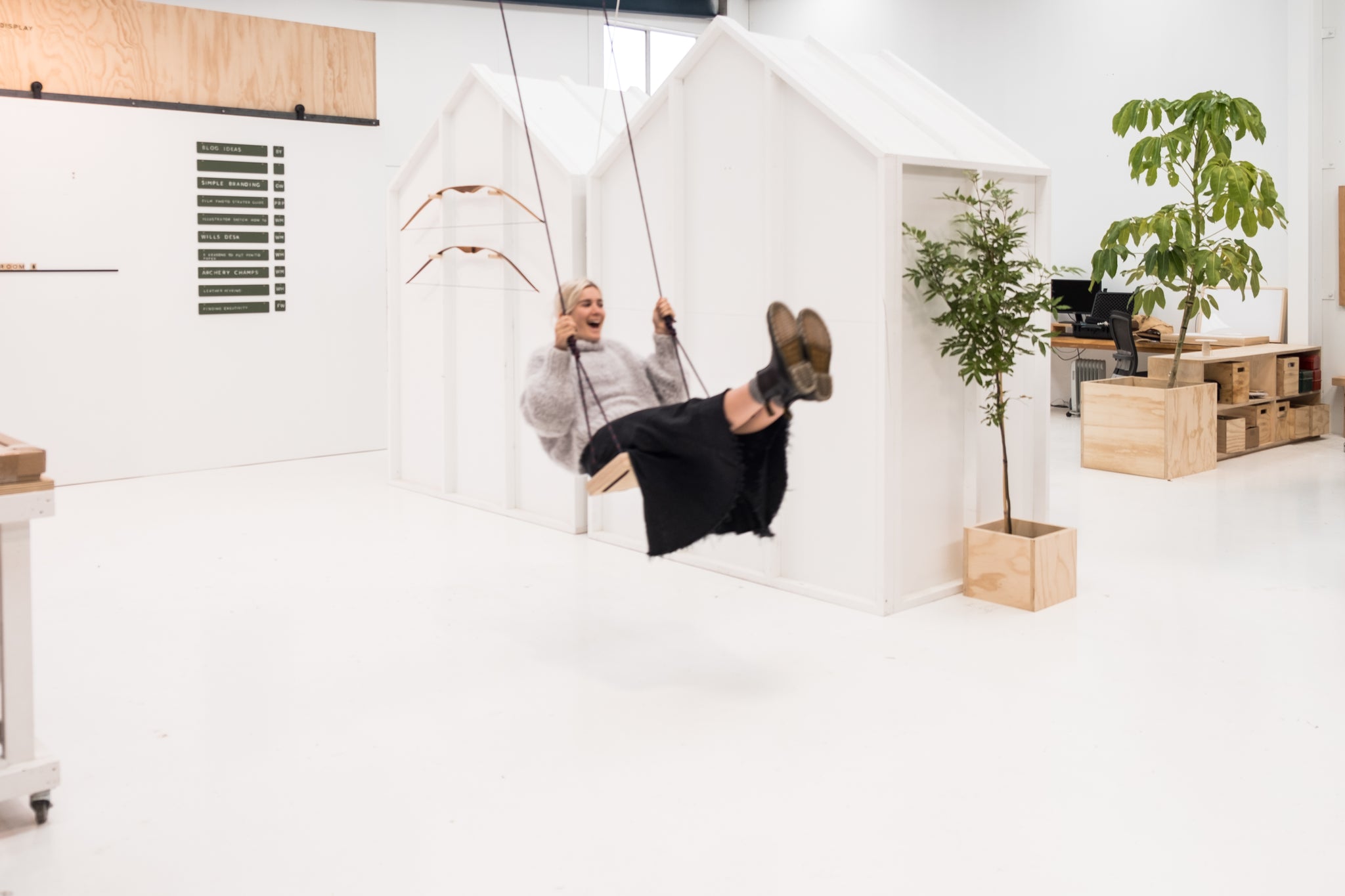 swing in white minimalistic office with house plants everywhere