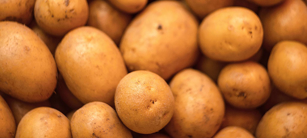 A close-up shot of large and medium-sized potatoes.
