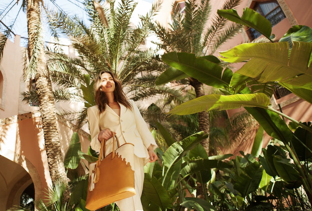 model holding a bag from abury collection windows and doorways