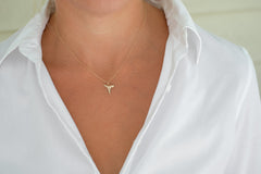 Foxy Fossil's Drop of Gold Shark Tooth Necklace around model's neck
