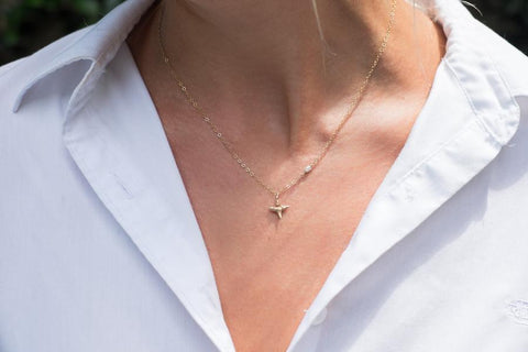 The Sullivan's Necklace with a shark tooth fossil pendant and a rice pearl on the chain