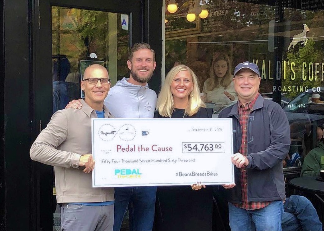 Kaldi's Coffee donating a check to Pedal the Cause