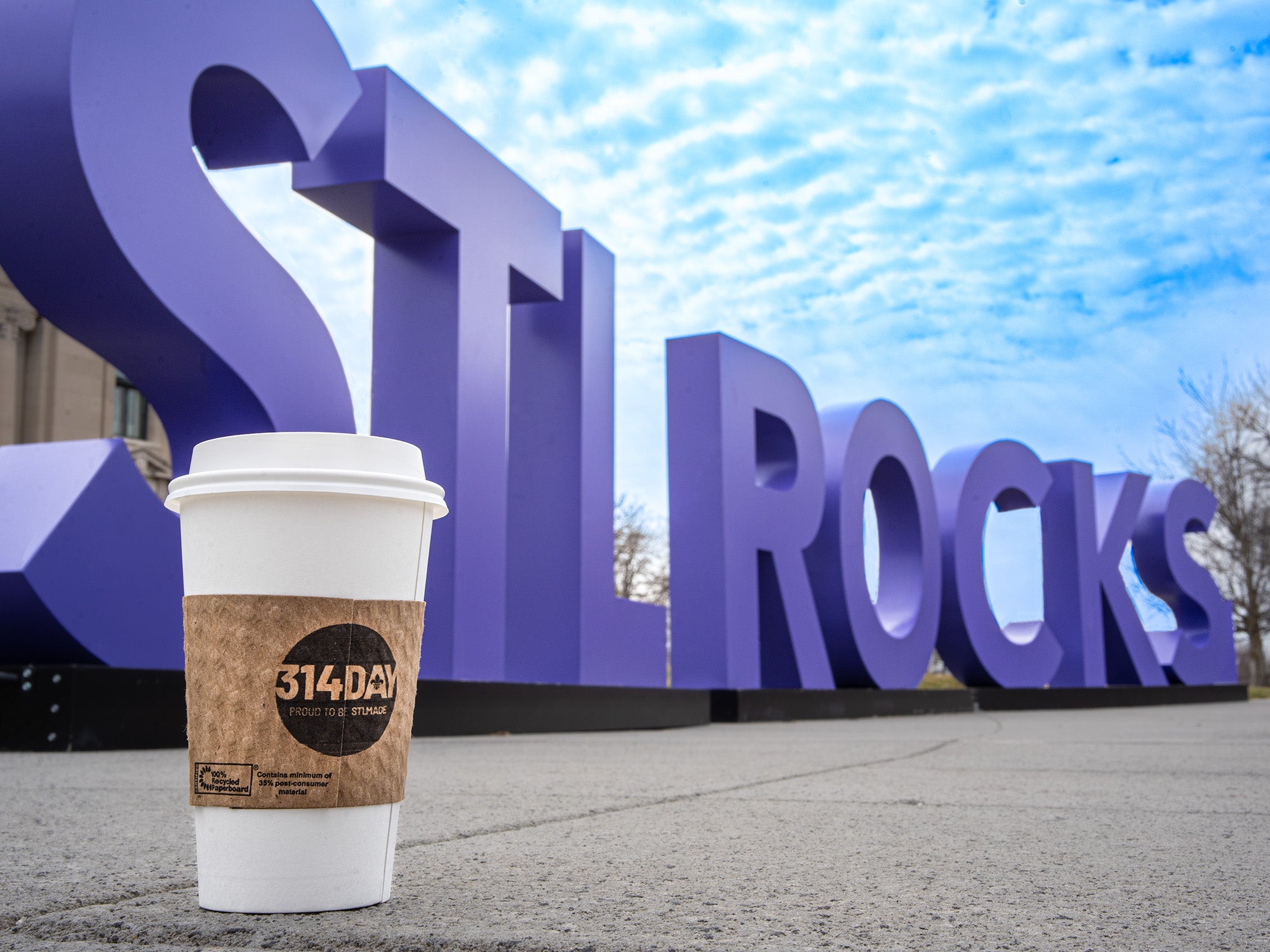 A Kaldi's cup sits in front of the MIssouri History Museum's STLROCKS sign