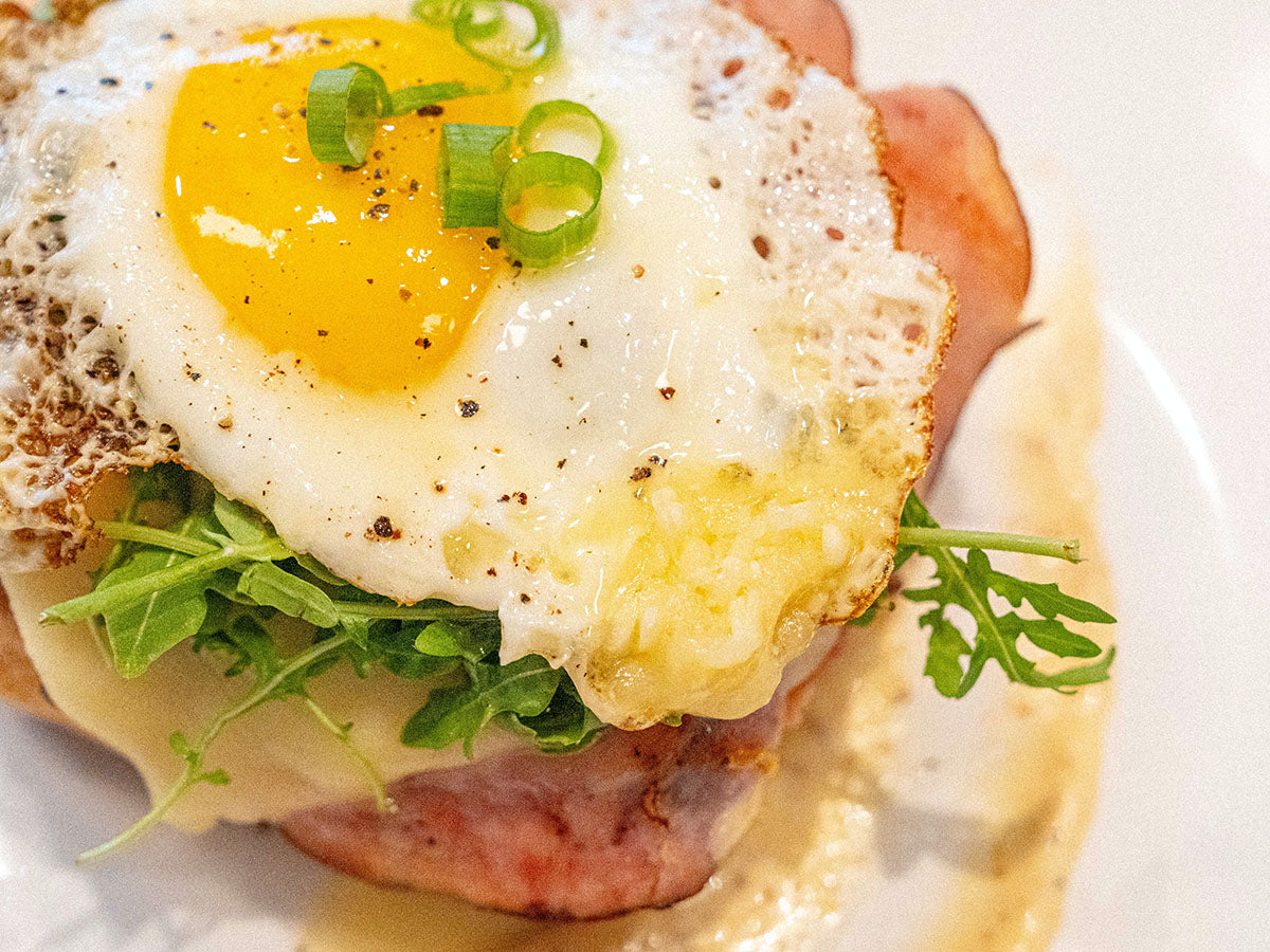 A sunny side up sits atop a croque du madame