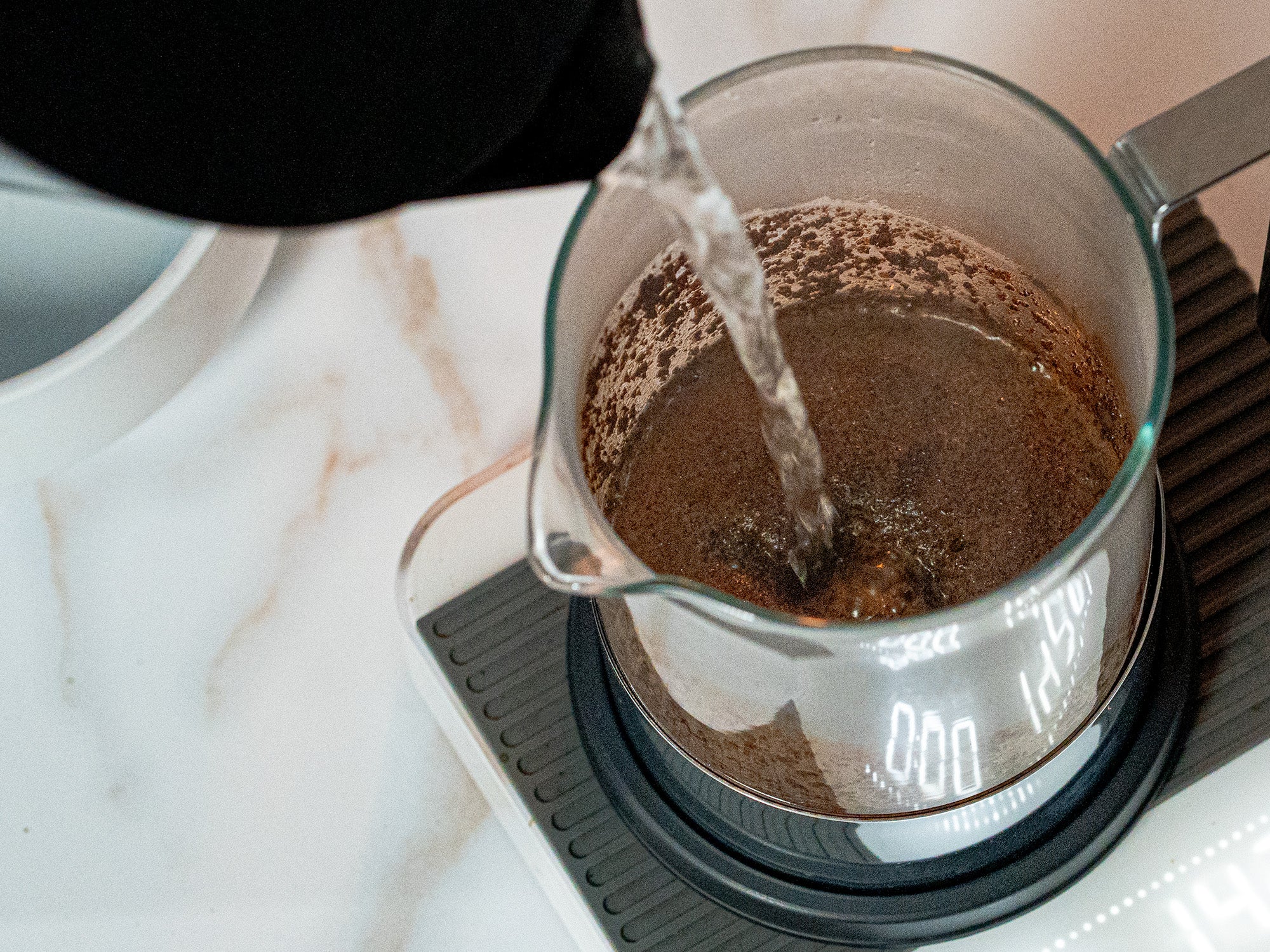 Water fills a French Press brewer