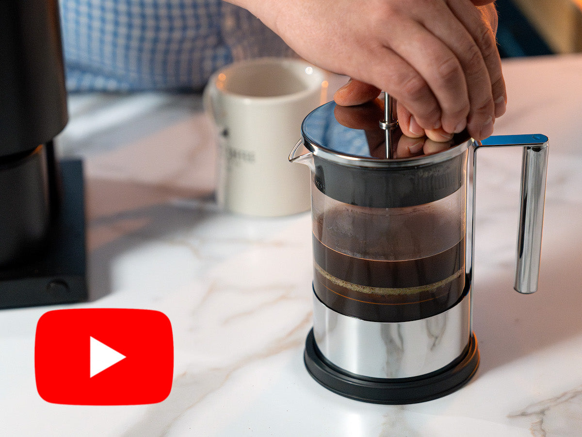 Pressing down on the French Press coffee maker