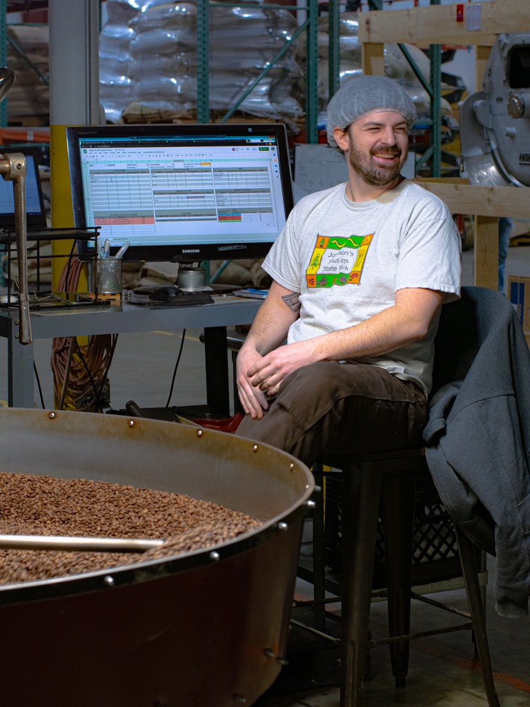 Jake smiling by the coffee roaster