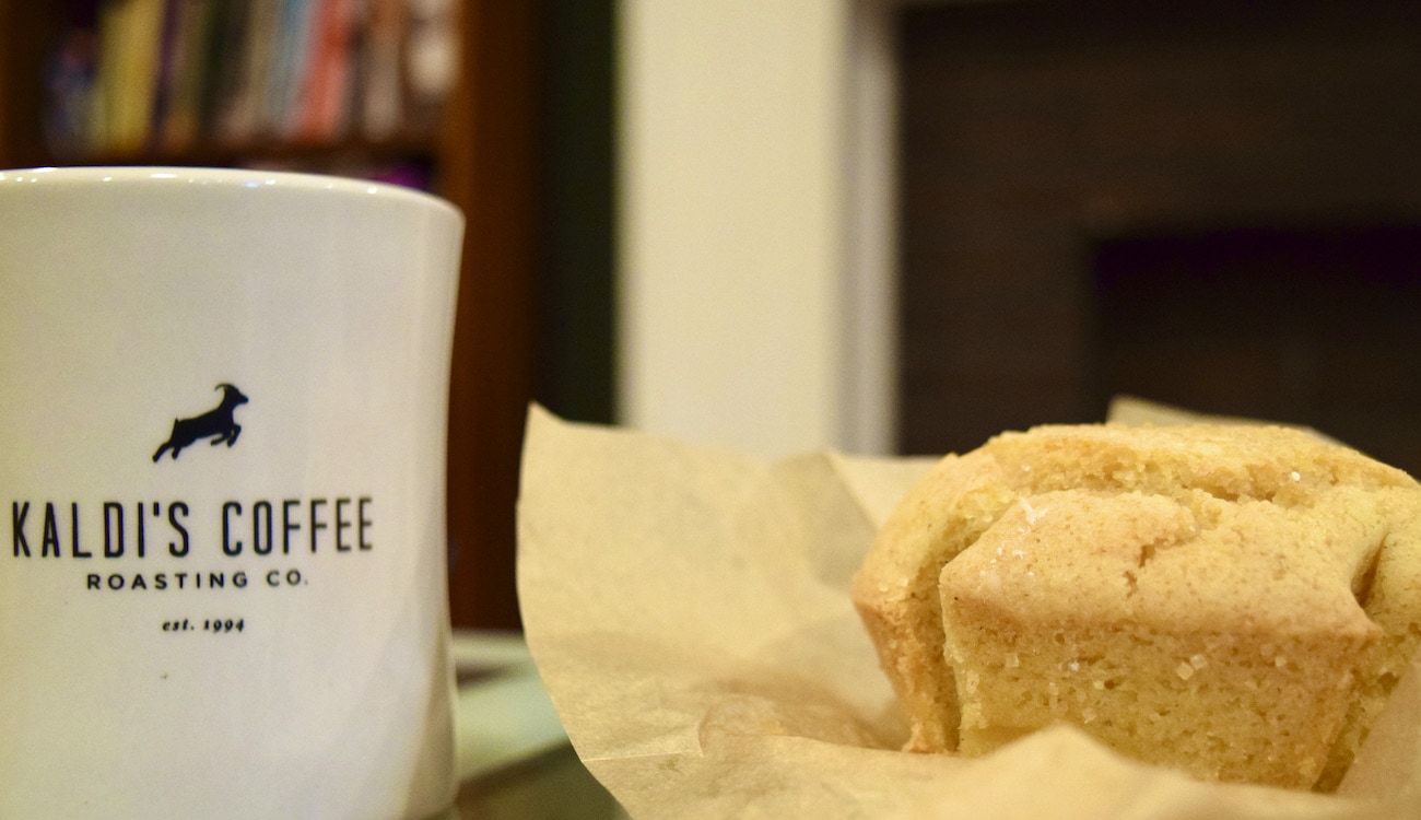 Orange Almond Muffin next to a mug of Kaldi's Coffee