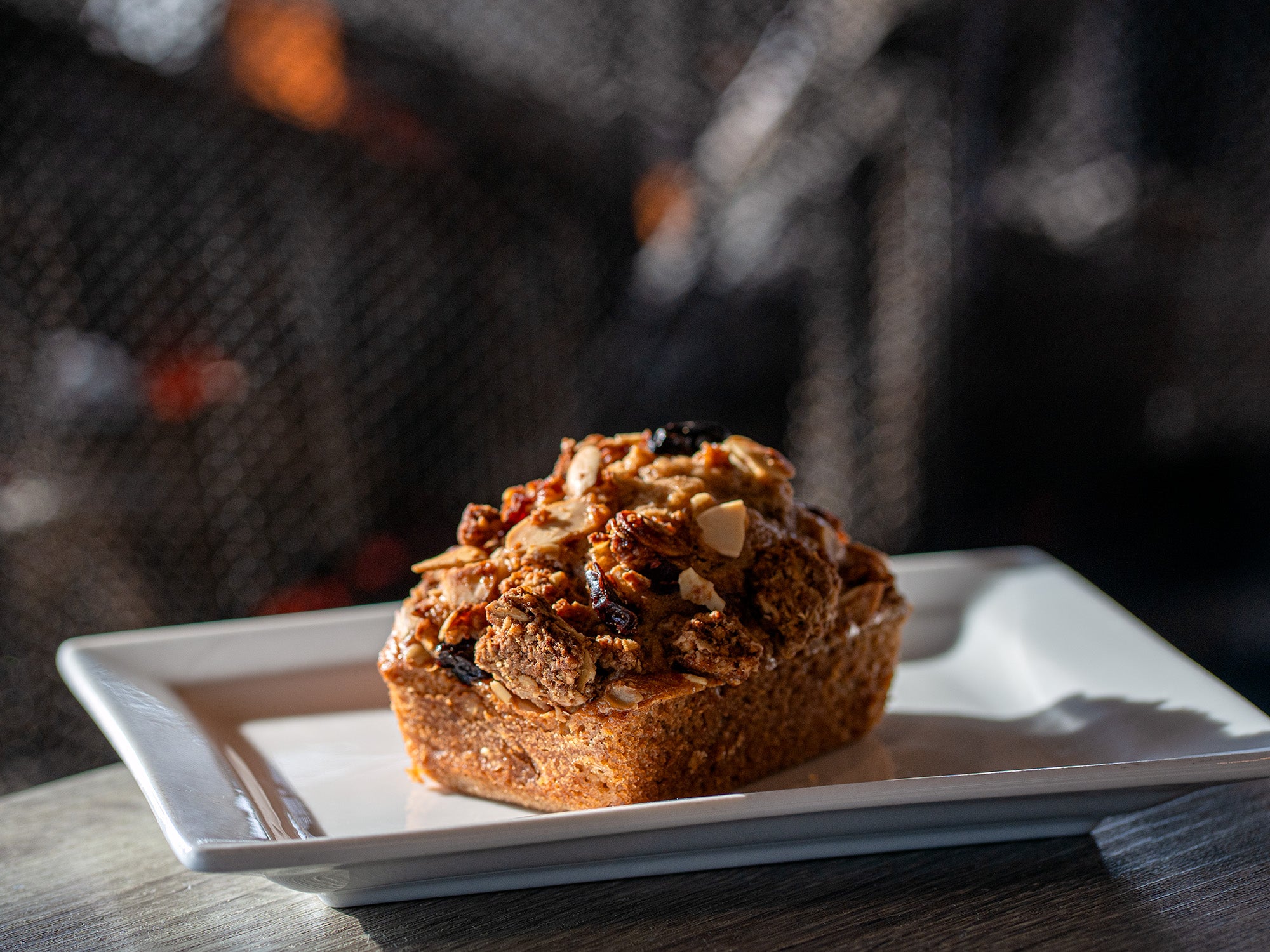 Apple cinnamon mini loaf in front of a fireplace