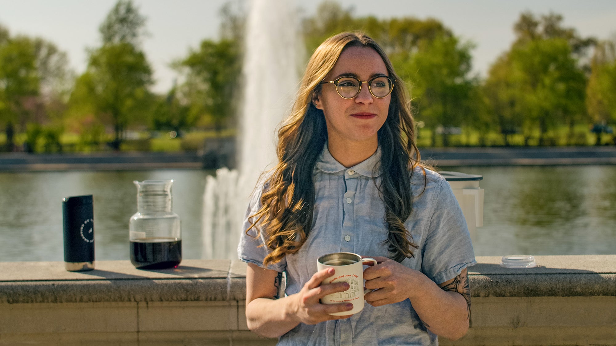 Maude drinks cold brew in Forest Park