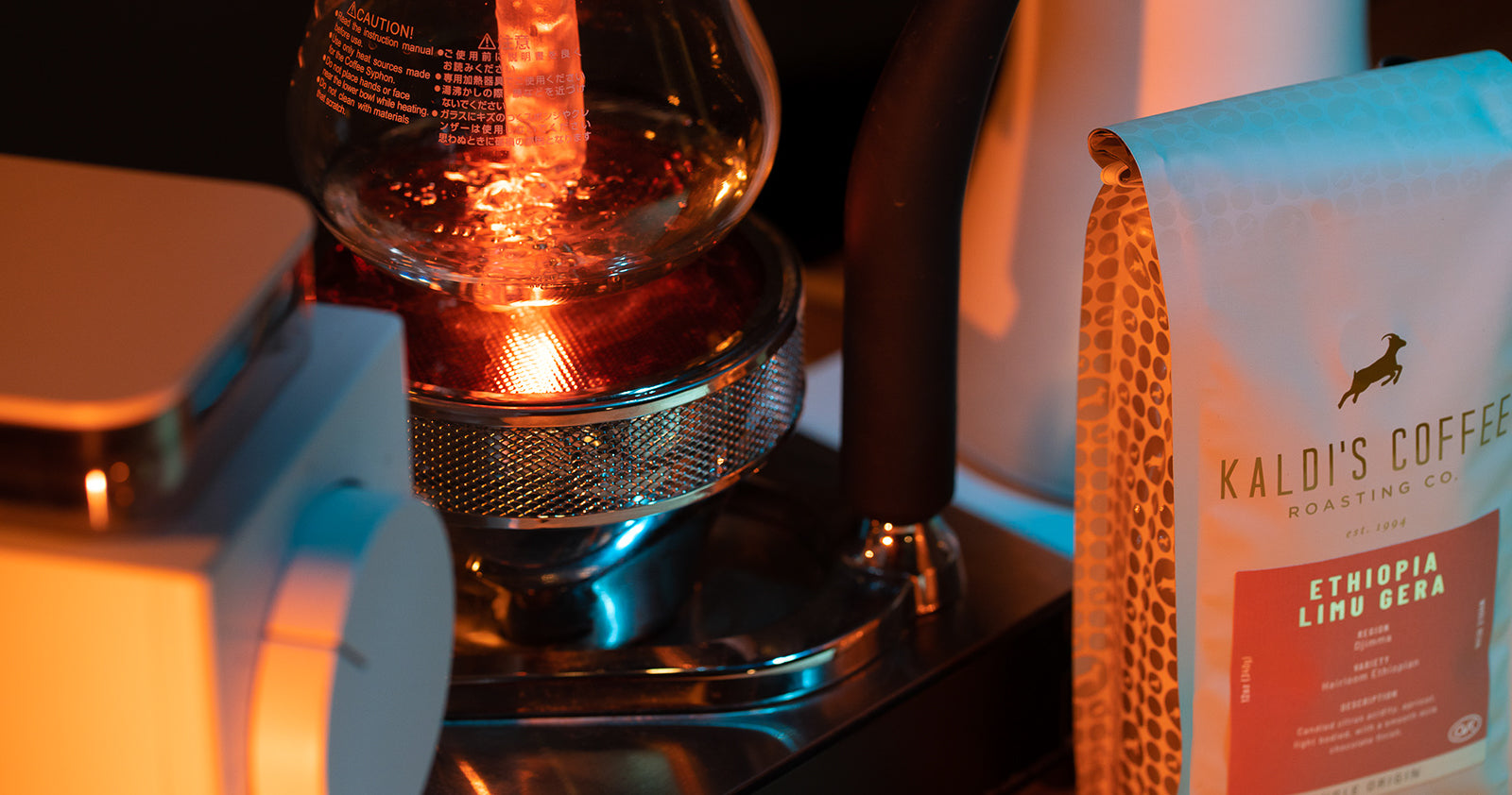 Bubbling water in the bottom chamber of a siphon coffee brewer