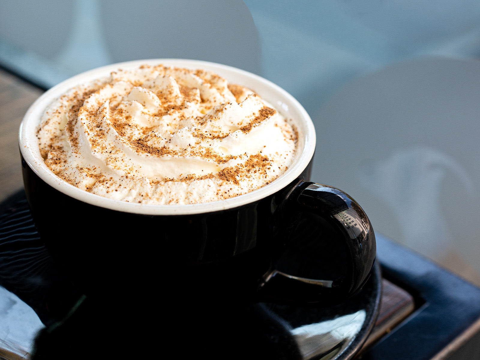 Gingersnap latte with whipped cream on table