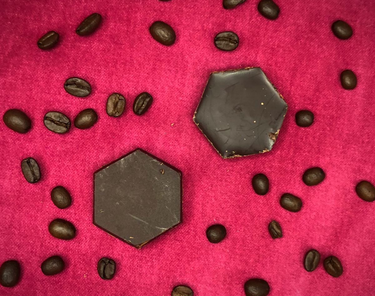 Chocolate Hexagons made with Birds and Bees coffee blend on a red pillow