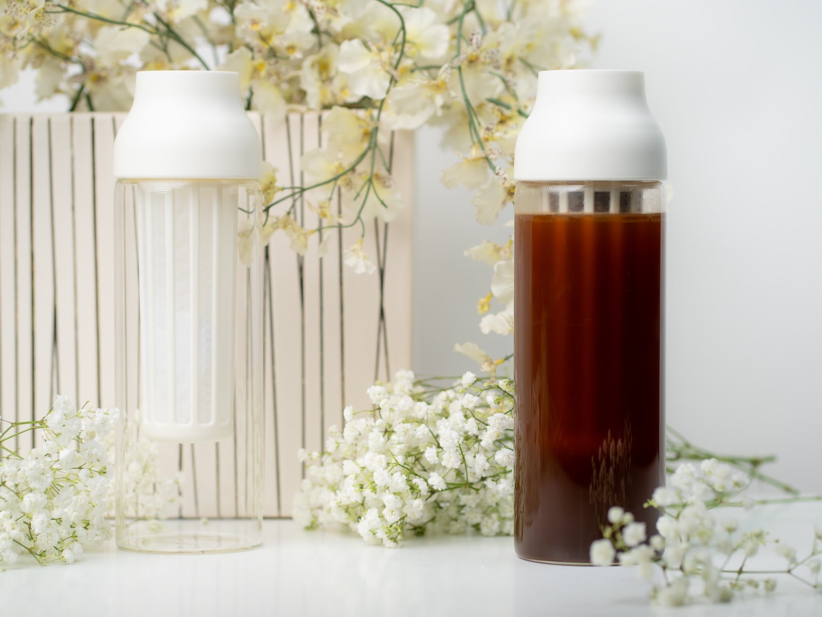 Kinto Capsule Cold Brew Maker next to flowers