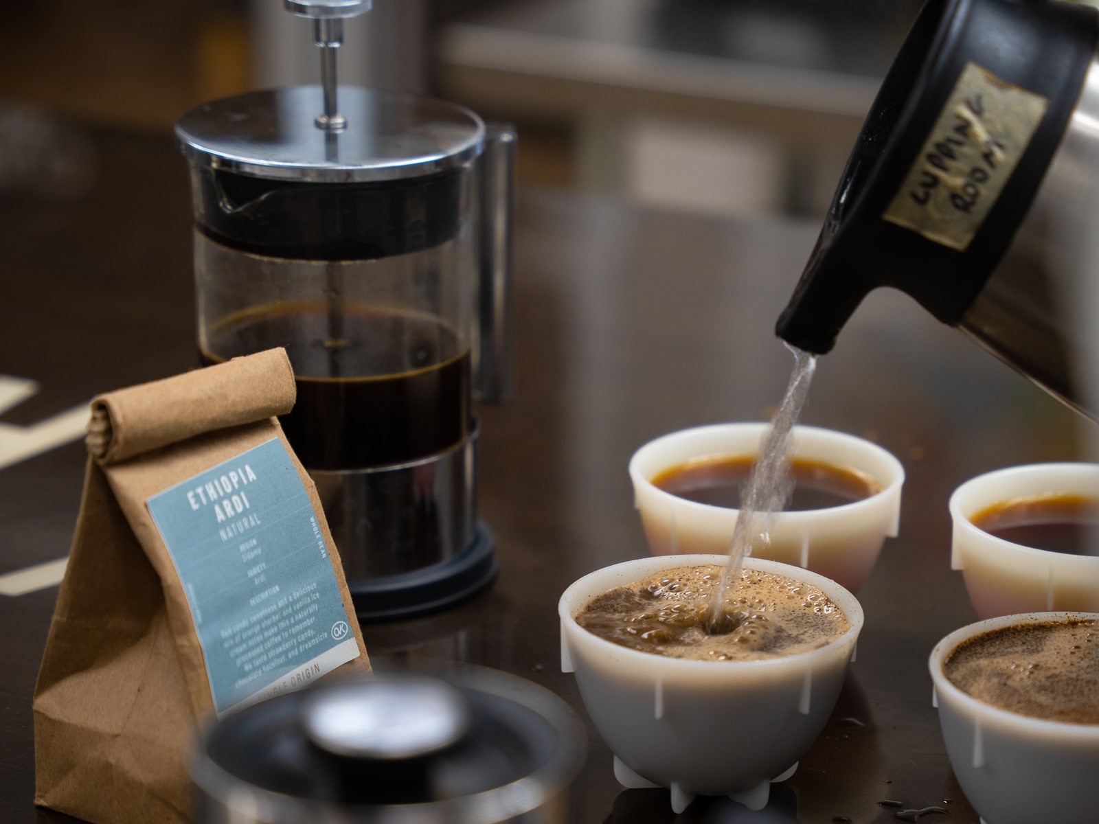 Pouring water into a cupping bowl of Ethiopia Ardi