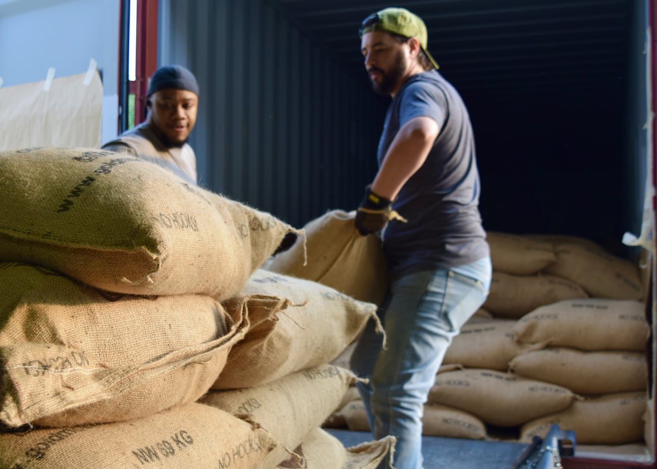 Unloading green coffee bags from a truck