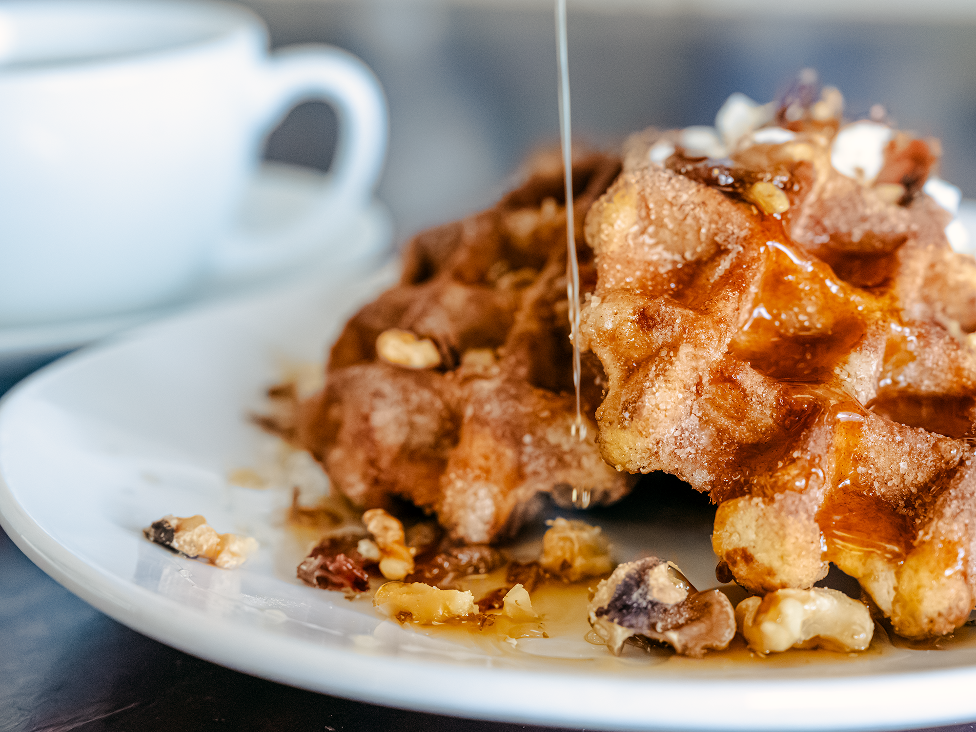 Maple Syrup drizzles across a Churro Waffle