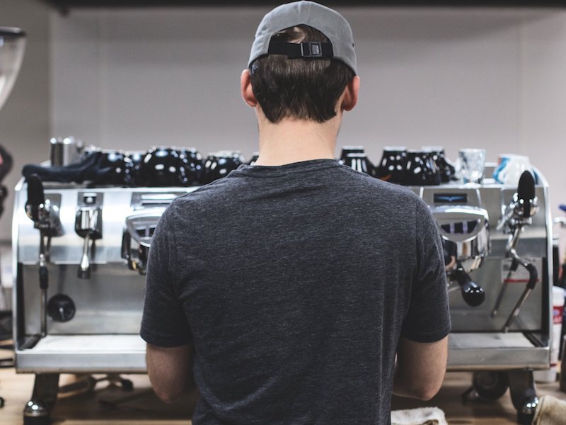 Performing Espresso Coffee Quality Control at our St. Louis Roastry, standing at our Black Eagle espresso machine