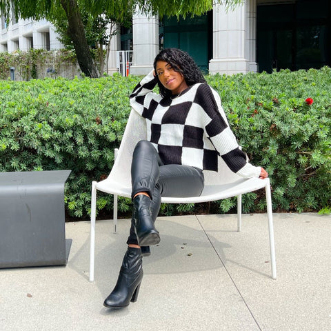 Black and white checkered sweater and medium wash mom jeans 