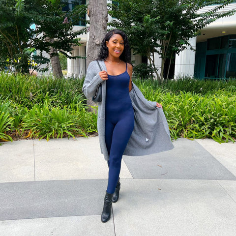 Heather grey knit cardigan and women's navy jumpsuit  